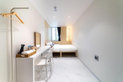 a bathroom with a vanity and a bed in a room at The Central Hongdae in Seoul