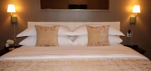 a large white bed with two pillows on it at Hotel Downtown Miami - DQR in Miami