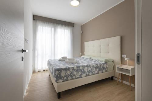 a bedroom with a large bed and a window at Rho Fiera-CityLife-SanSiro- 20 minutes from the Duomo in Milan