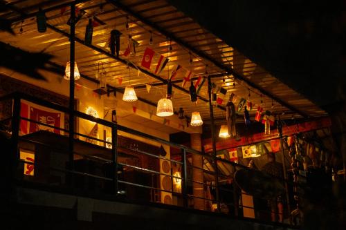 a restaurant with lights hanging from the ceiling at Airport Tourist Hostel in Katunayake