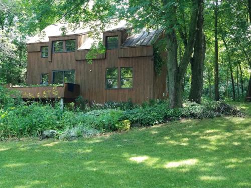 a house in the middle of a yard at Lakefront Chalet in Montreal in Montréal