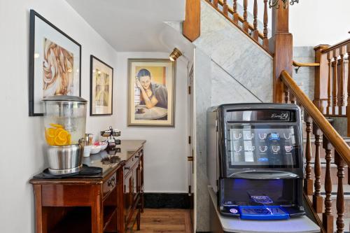 a kitchen with a counter with a blender and a stairs at The Andrews Hotel in San Francisco