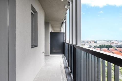 a balcony with a view of a city at Merlata Suite - 8 min from M1 - private parking in Pero