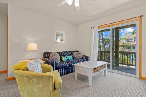 a living room with a couch and a table at 1600 - 5 O`clock Somewhere in Corolla