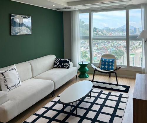 a living room with a couch and a chair at YEOSU Night Sea, Hotel Bedding in Wagol
