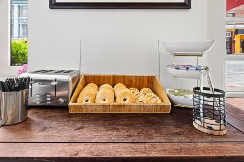a tray of donuts in front of a toaster oven at The Andrews Hotel in San Francisco