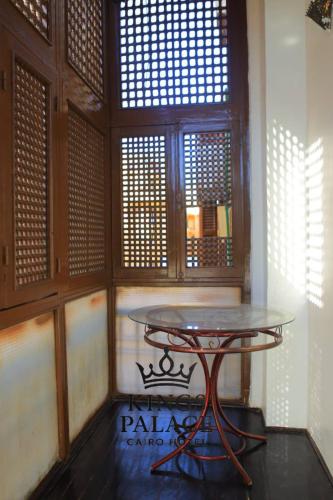 a table sitting in a room with a window at King Palace Cairo Hotel in Cairo