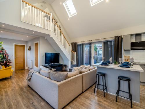 a living room with a couch and a kitchen at Ferndale Bungalow in Hambleton