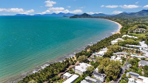 an aerial view of a beach with houses and the ocean at Azul at Island Views—Bask in Beachfront Living in Palm Cove