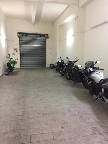 a row of motorcycles parked in a garage at Alhambra "Etna Charme" - Guest House in Giarre