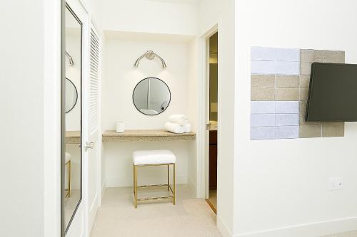 a bathroom with a mirror and a stool at Perfect Location 2BR 5 Min Walk to Galleria Marquee Uptown in Houston
