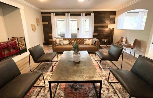 a living room with a couch and a table and chairs at Swim Spa Billiards in Pineforest Spacious Home in Bastrop