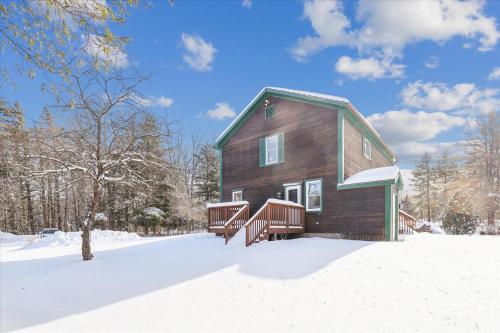 a wooden house in the snow in the snow at Elmore Meadows in Stowe