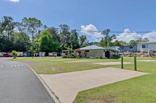 a park with a building and a road at Yandina Caravan Park in Yandina