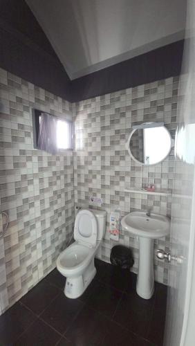 a bathroom with a toilet and a sink at Grace Riverfront in Lat Krabang
