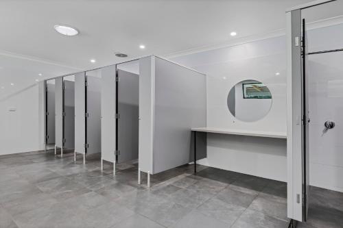 a row of mirrors in a room with a counter at Yandina Caravan Park in Yandina