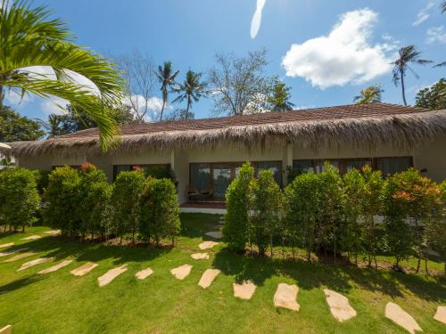 a house with a grass roof at Terramar Villas in Kuta Lombok