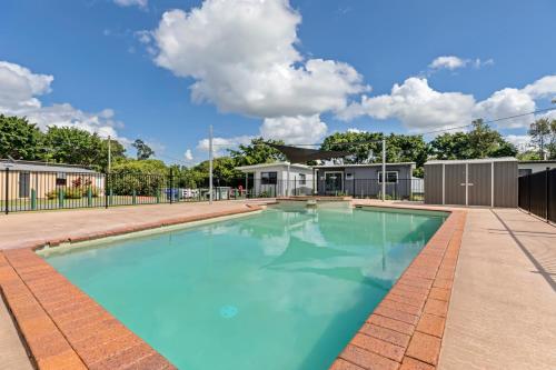 a large swimming pool with blue water at Yandina Caravan Park in Yandina