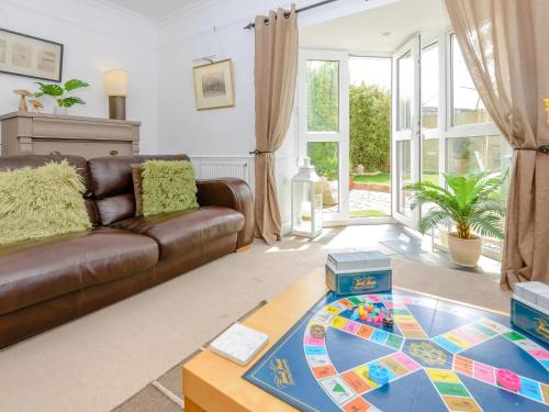 a living room with a couch and a table at Number 1 Admiralty Cottages in Alverstoke