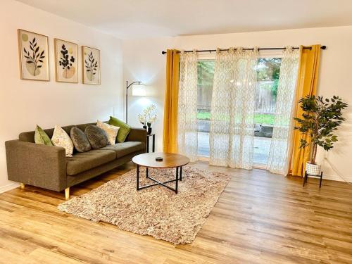 a living room with a couch and a table at Elegant Townhome Retreat in Lynnwood in Lynnwood