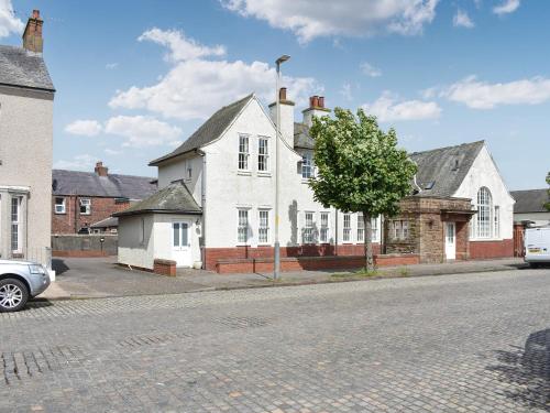 a white house on the side of a street at The Police Station - Uk45642 in Silloth