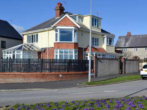 a house with a fence and purple flowers in front of it at Fisherman's Friend - Uk30742 in Bridlington