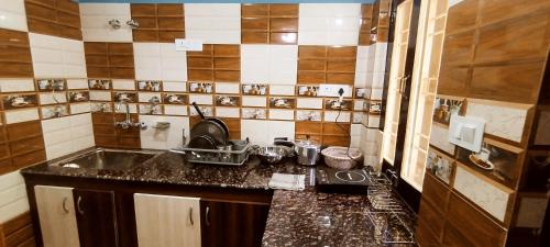 a kitchen with a sink and a counter top at Aasara Homestay Bhimtal in Bhīm Tāl