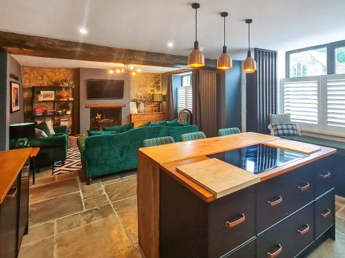 a living room with a couch and a table at Verona House in Tideswell