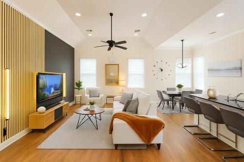 a living room with a couch and a tv at Shop, Soak &Sleep Galleria 3BR Retreat Private Jacuzzi in Houston