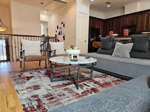 a living room with a couch and a table at Galleria Comfort 3BR King Bed Private Jacuzzi and Garage in Houston