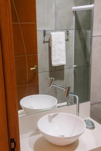 a bathroom with a white sink and a shower at Bistu Hotel - Vila Nova Conceição in Sao Paulo