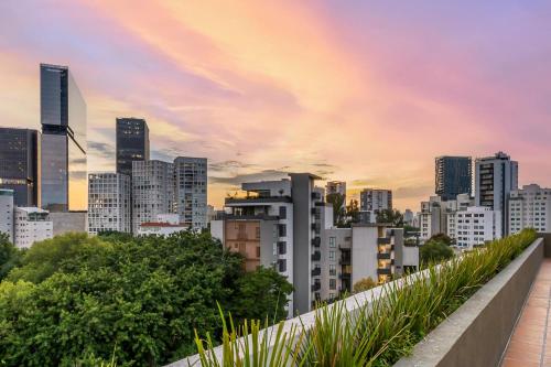 a view of a city skyline at sunset at Dhaus Country Club in Guadalajara