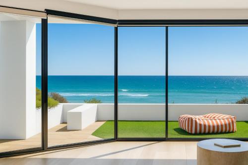 a living room with a view of the ocean at Henley Beachfront Luxury Home With Sauna Just 200m From Henley Square! in Henley Beach