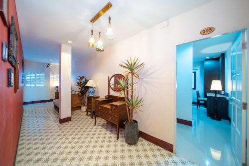 a hallway with a living room with a desk at Nyonya Maison Boutique Hotel Phuket Old Town in Phuket Town