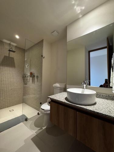 a bathroom with a sink and a toilet and a shower at New apartment in Yu Country GDL view 22nd floor in Guadalajara