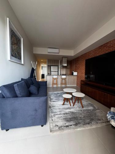 a living room with a blue couch and tables at New apartment in Yu Country GDL view 22nd floor in Guadalajara