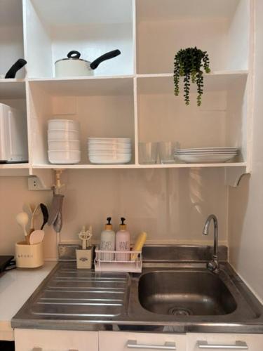 a kitchen with a sink and a counter top at Dainty Den LS217- Chic & Relaxing Stay Near Enchanted Kingdom in Santa Rosa