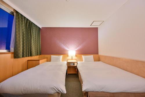 Postel nebo postele na pokoji v ubytování Central Hotel Sasebo