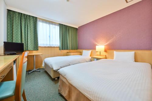 Postel nebo postele na pokoji v ubytování Central Hotel Sasebo