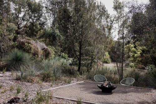 a garden with a fountain in the middle of a field at Spring Beach Rise in Spring Beach