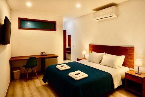 a hotel room with a bed with two towels on it at Bistu Hotel - Vila Nova Conceição in Sao Paulo