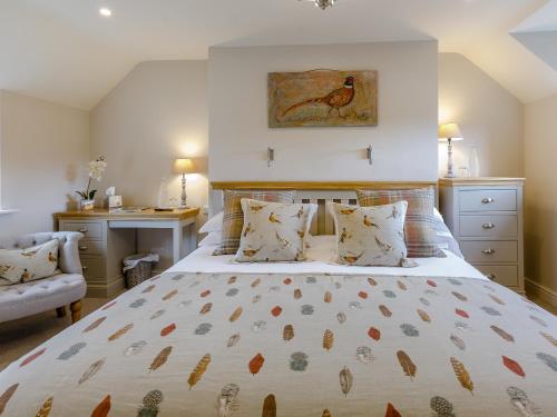 a bedroom with a large bed and a desk at The Grousemoor in Llandegla