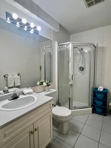 a bathroom with a sink and a shower and a toilet at Lovely suite in Burnaby
