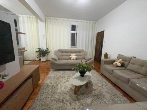 a living room with two couches and a table at Apartamento inteiro 2 quartos Porto Barra Vista Mar in Salvador