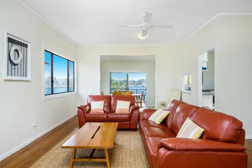 a living room with two leather couches and a coffee table at SunnySide in Evans Head