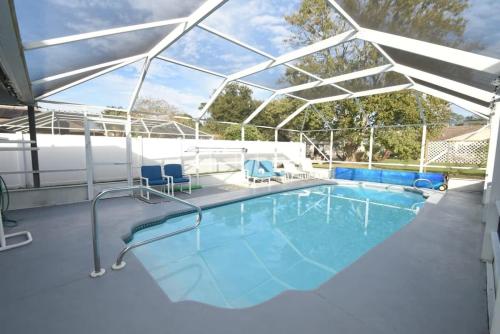 a large swimming pool with a glass roof at Cozy Family Pool Home in Palm Coast in Palm Coast