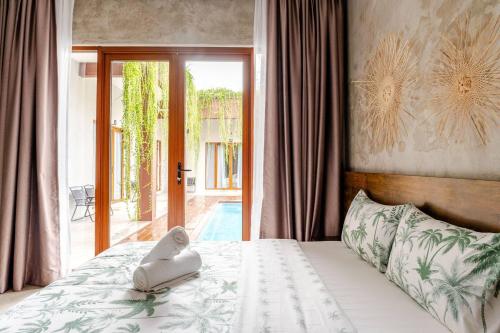 a bedroom with a bed and a sliding glass door at Chrisenbel Hideaway Retreat in Petaling Jaya