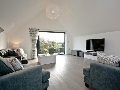a living room with two couches and a flat screen tv at Black Sea Horse in Westward Ho