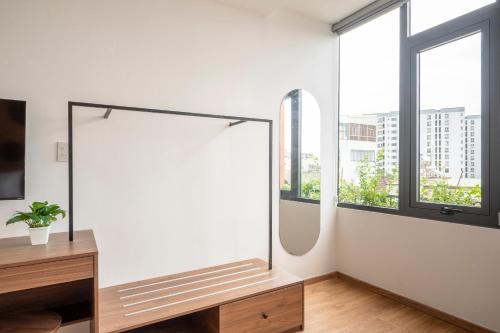 a dressing room with a mirror and windows at La Hotel Nguyen Van Dung in Ho Chi Minh City