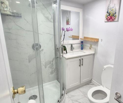 a bathroom with a shower and a toilet and a sink at Deluxe Queen Rooms with Privated Bathroom in Toronto